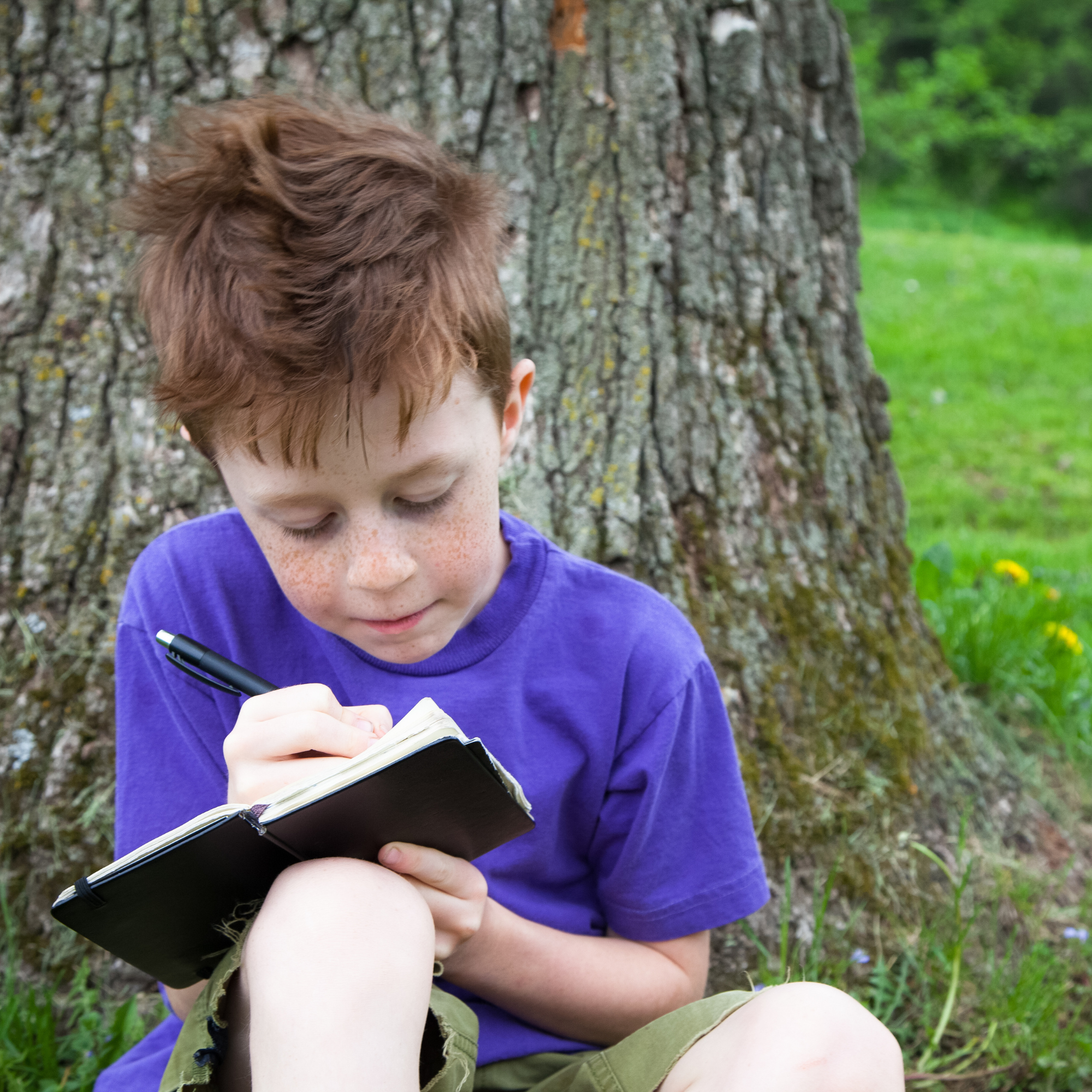 a-young-boy-writing-in-a-journal